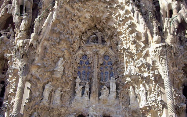 Sagrada Familia intricate facade details in Barcelona, part of guided tour with transportation.