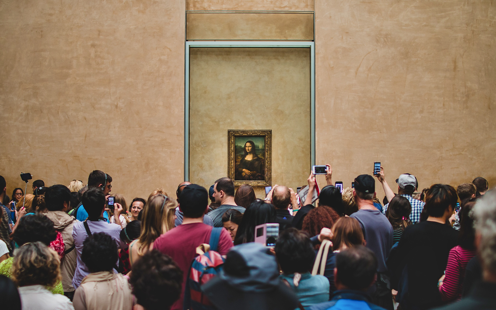 Crowd viewing the Mona Lisa at the Louvre Museum in Paris.