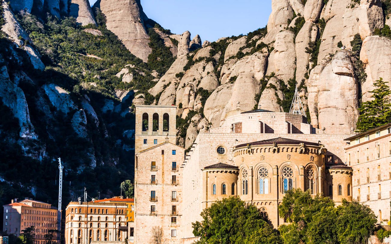 Montserrat Monastery nestled in rocky mountain landscape, Spain.