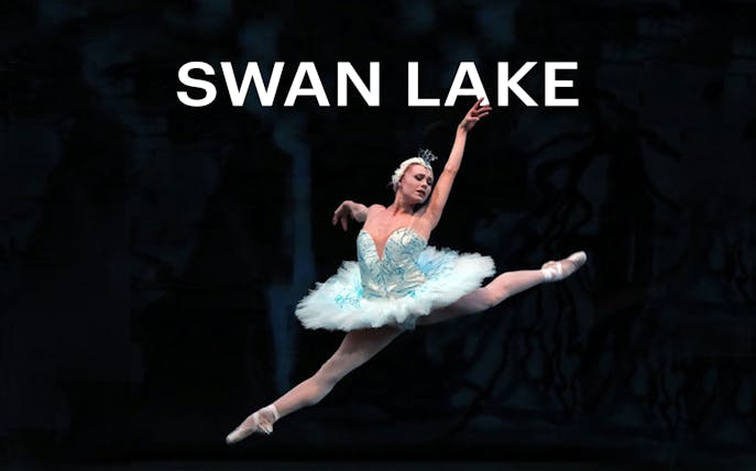 Ballerina performing a leap in Swan Lake ballet.