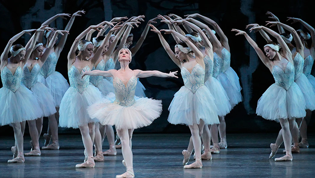 Ballet dancers performing Swan Lake on stage.