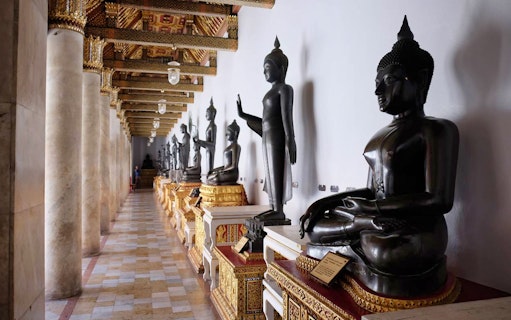 Buddha statues in a temple corridor, Ayutthaya UNESCO site, Thailand.
