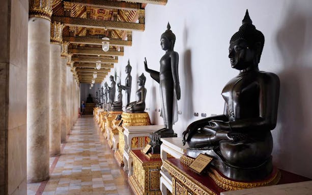 Buddha statues in a temple corridor, Ayutthaya UNESCO site, Thailand.