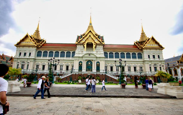 Grand Palace in Bangkok with tourists exploring the grounds.