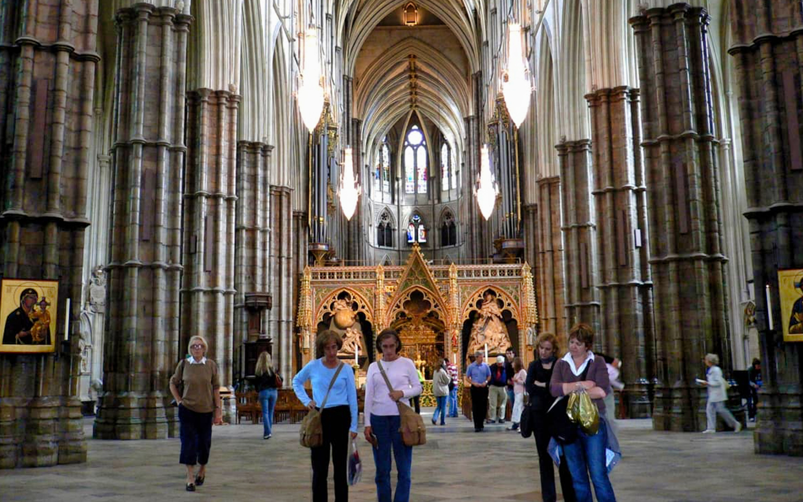 Westminster Abbey interior with visitors exploring the historic architecture.
