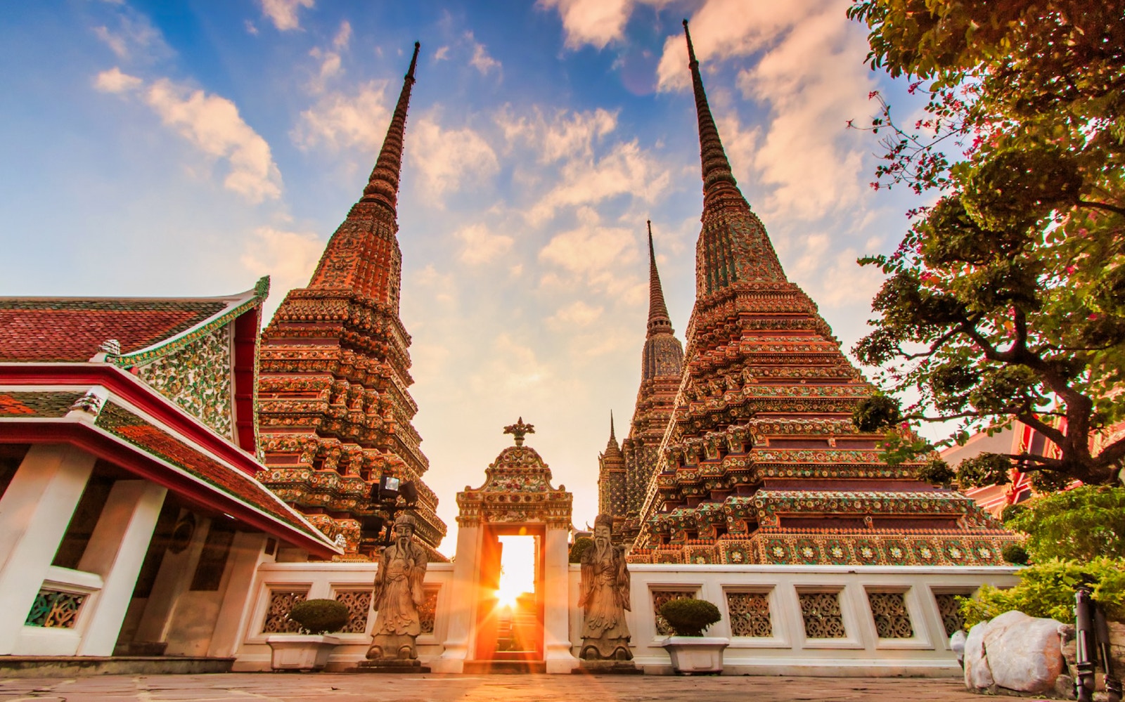 Wat Arun temple spires at sunset in Bangkok, part of Klong and Flower Market tour.