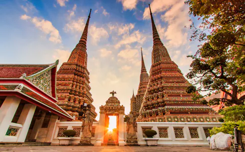 Wat Arun temple spires at sunset in Bangkok, part of Klong and Flower Market tour.