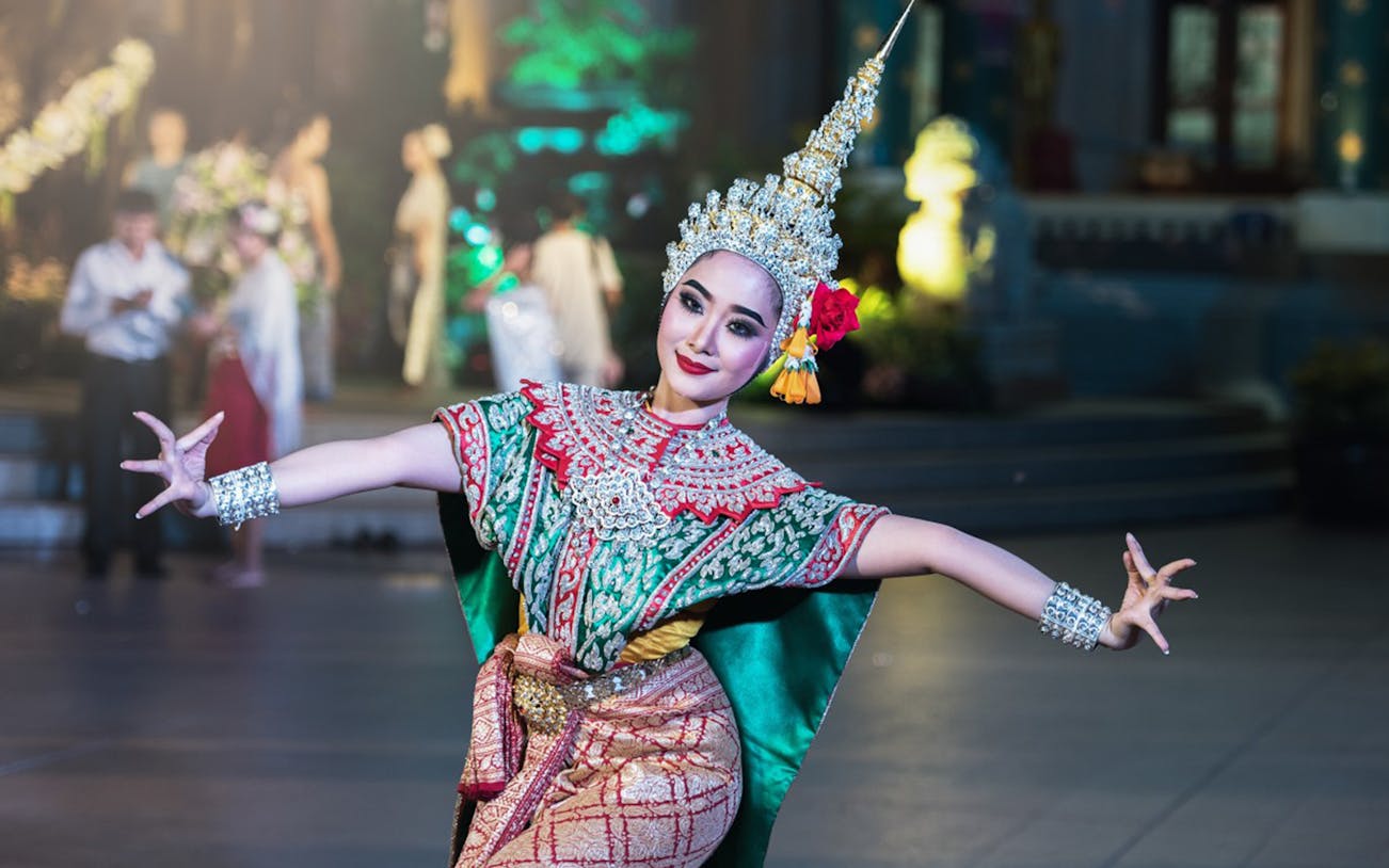 Traditional Thai dancer performing on a vertical cruise with seafood buffet.