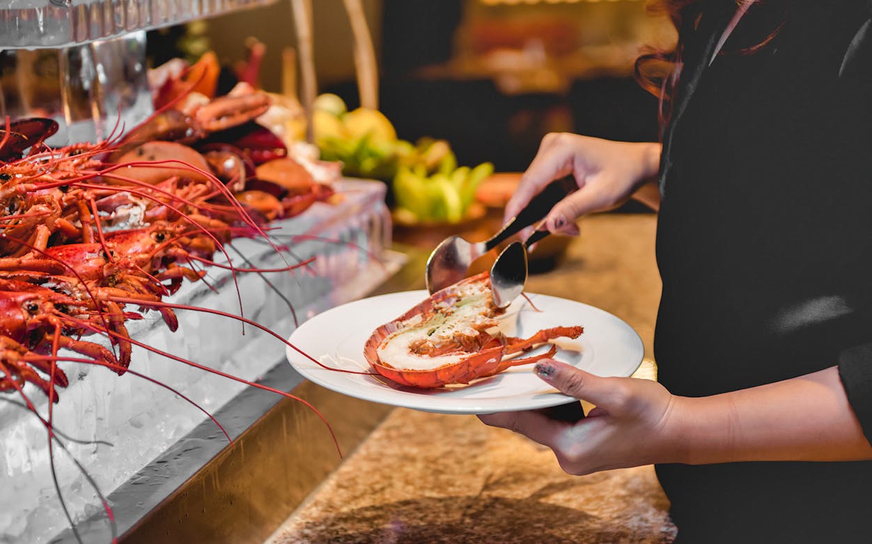 Seafood buffet with lobster being served on a vertical cruise.