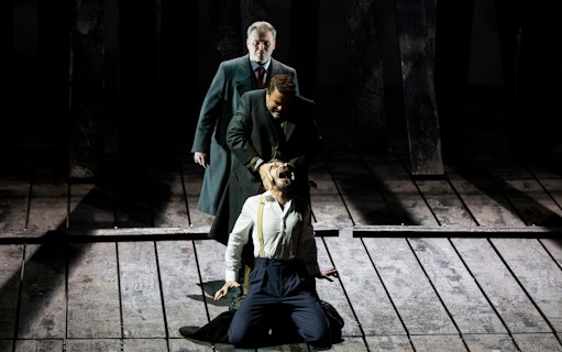 Stage performance of a dramatic scene from King Lear with three actors.