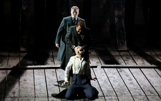 Stage performance of a dramatic scene from King Lear with three actors.