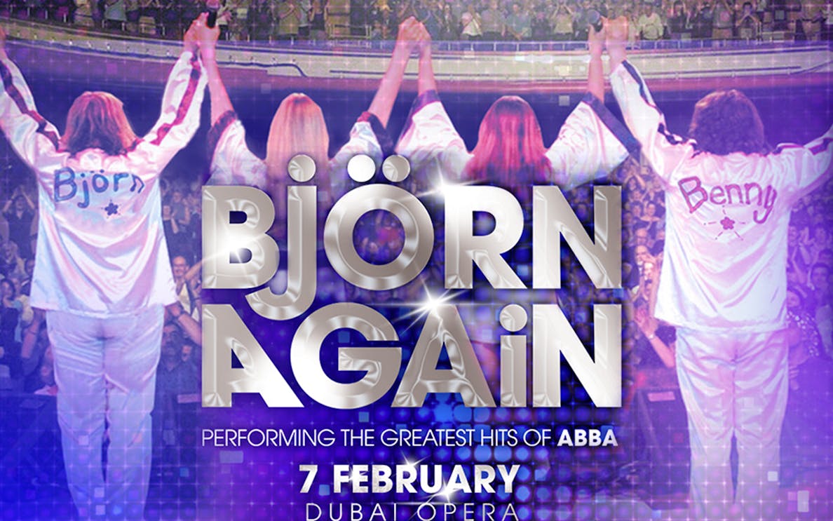 Bjorn Again performing ABBA hits at Dubai Opera, audience cheering.