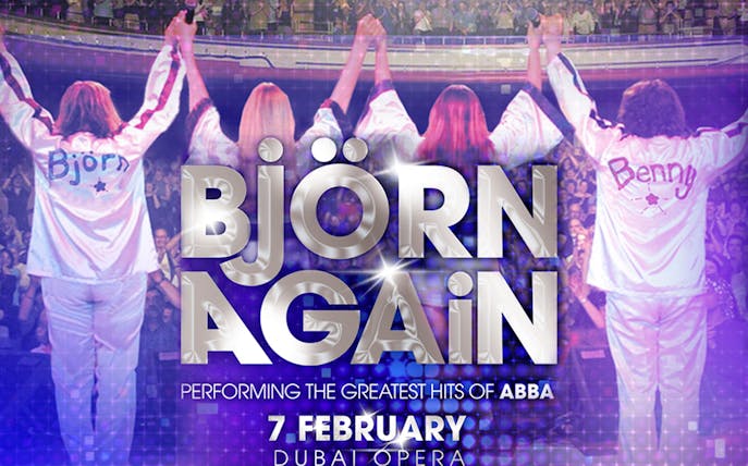 Bjorn Again performing ABBA hits at Dubai Opera, audience cheering.