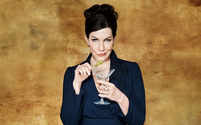 Woman holding a martini glass with olives, related to Agrippina tour.