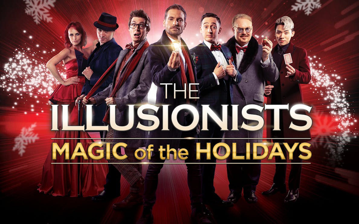 Illusionists performing holiday magic show with festive background.