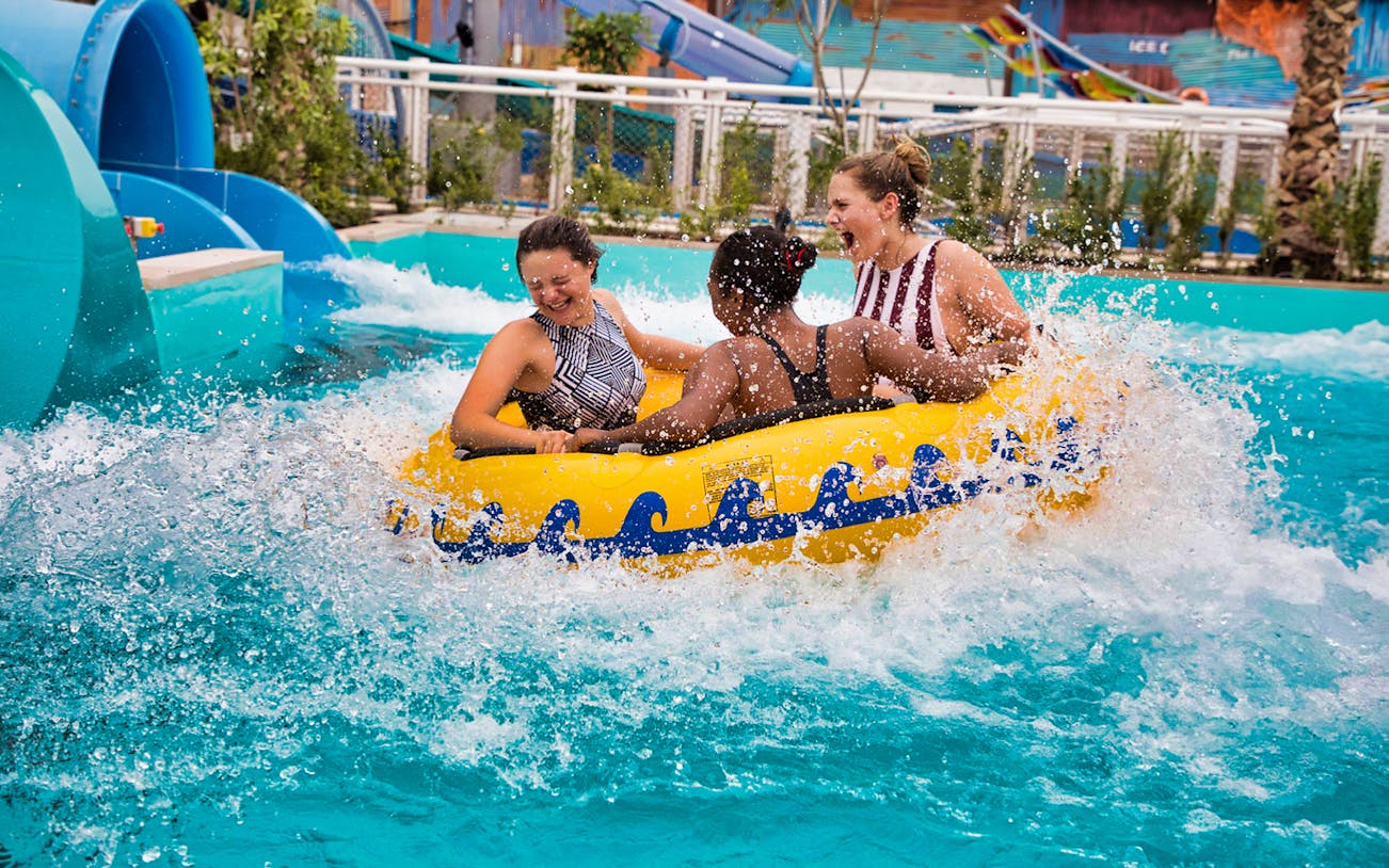 People enjoying a water ride at a Dubai water park.