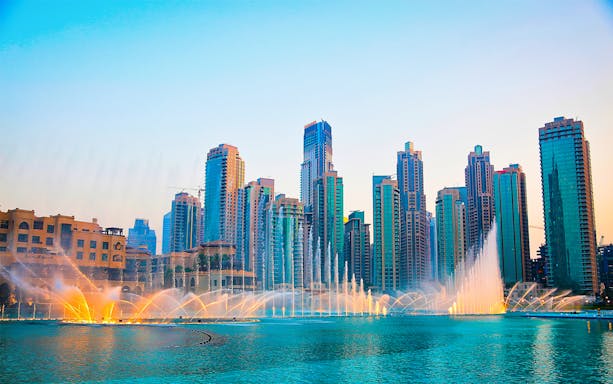 Dubai Fountain show with city skyline in the background, Explore The Emirates.