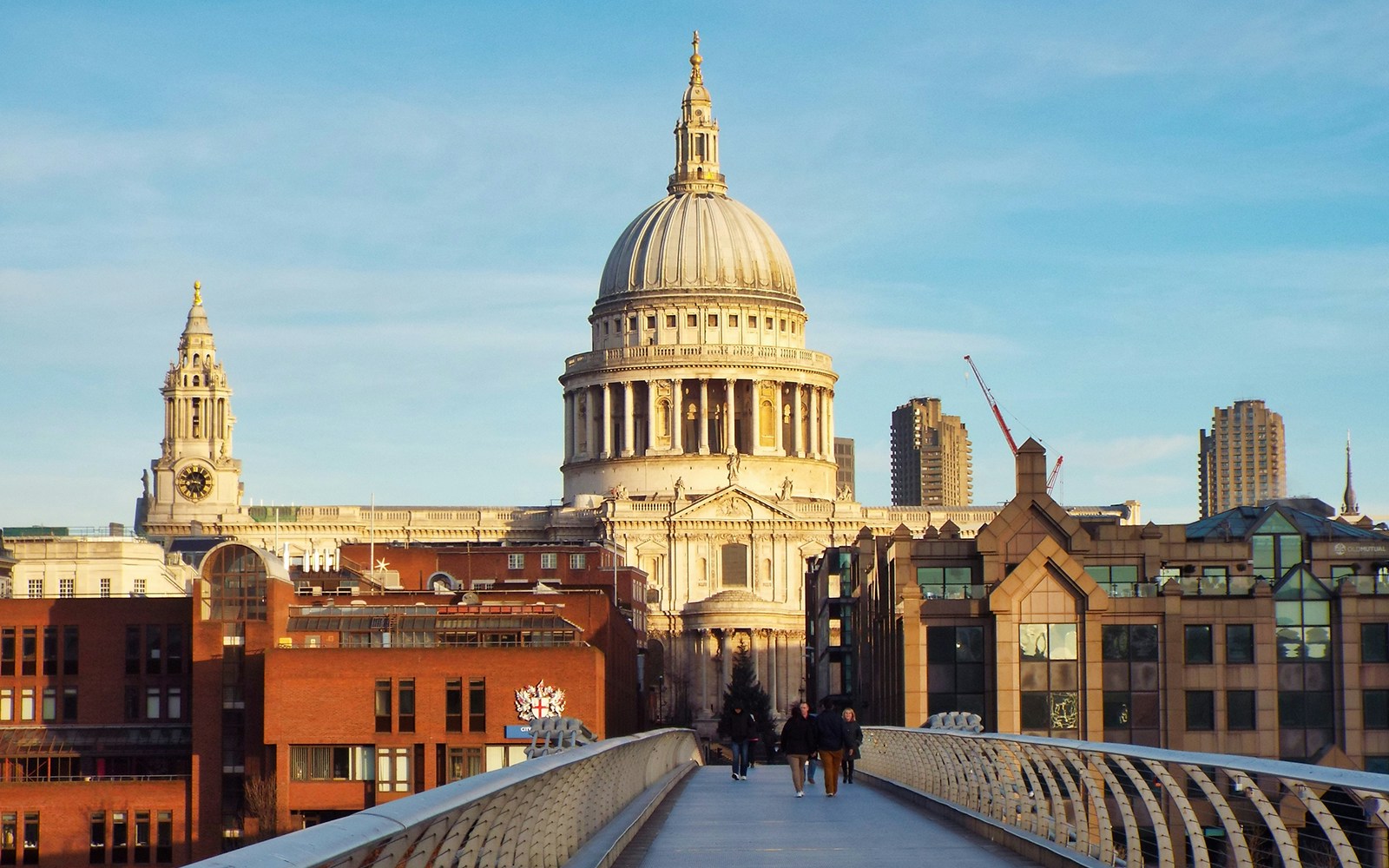 Tourists enjoying the Golden Tours 24Hrs London Hop On Hop Off bus with a view of St Paul's Cathedral in the background