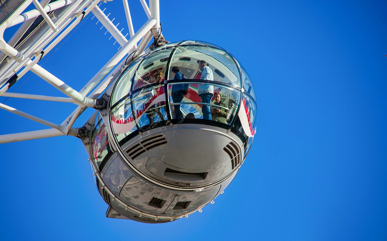 London double-decker bus near Tower of London with view of the London Eye, Golden Tours.