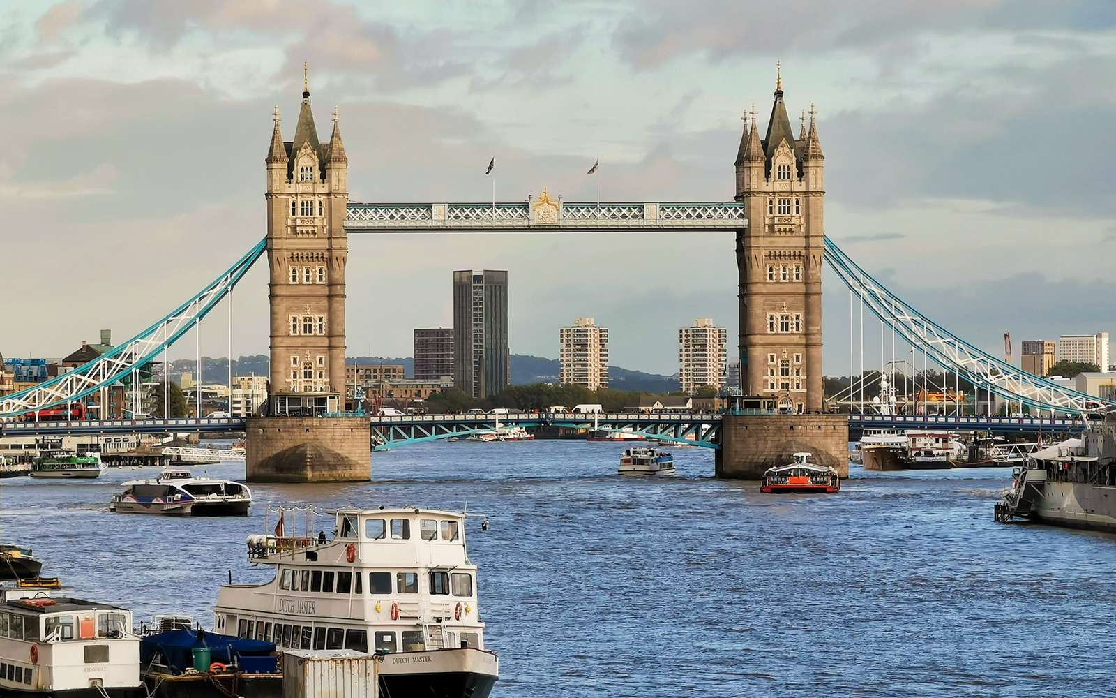 Tower Bridge over the River Thames in London with boats passing underneath.
