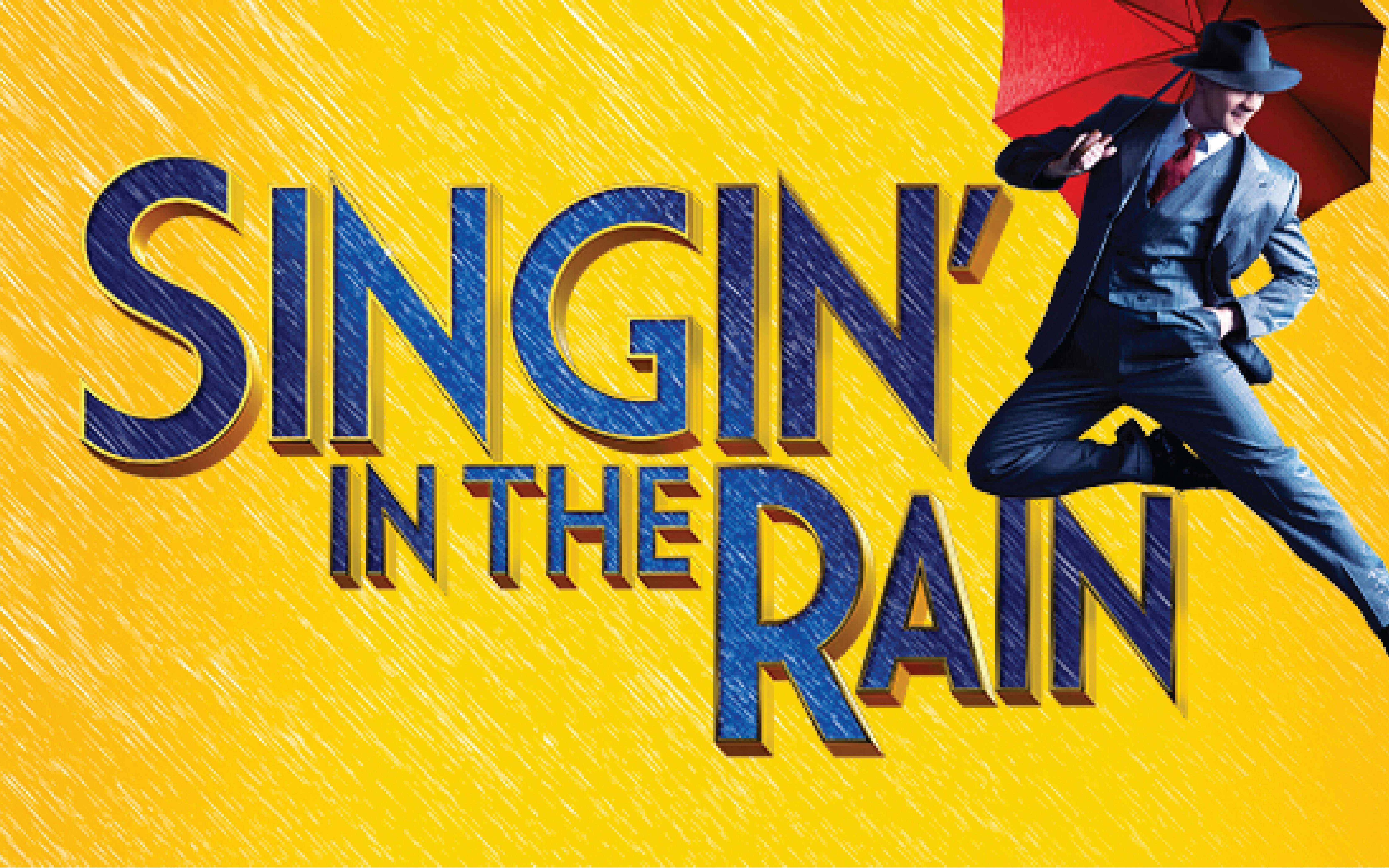Performers dancing with umbrellas on stage during Singin' In The Rain musical.