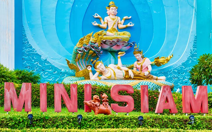 Mini Siam entrance with intricate Thai sculptures, Pattaya, Thailand.