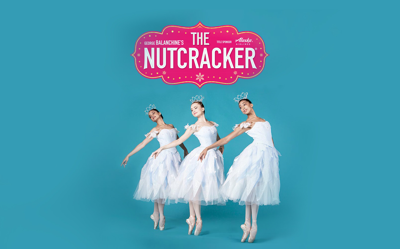 Ballet dancers in white costumes performing George Balanchine's The Nutcracker.