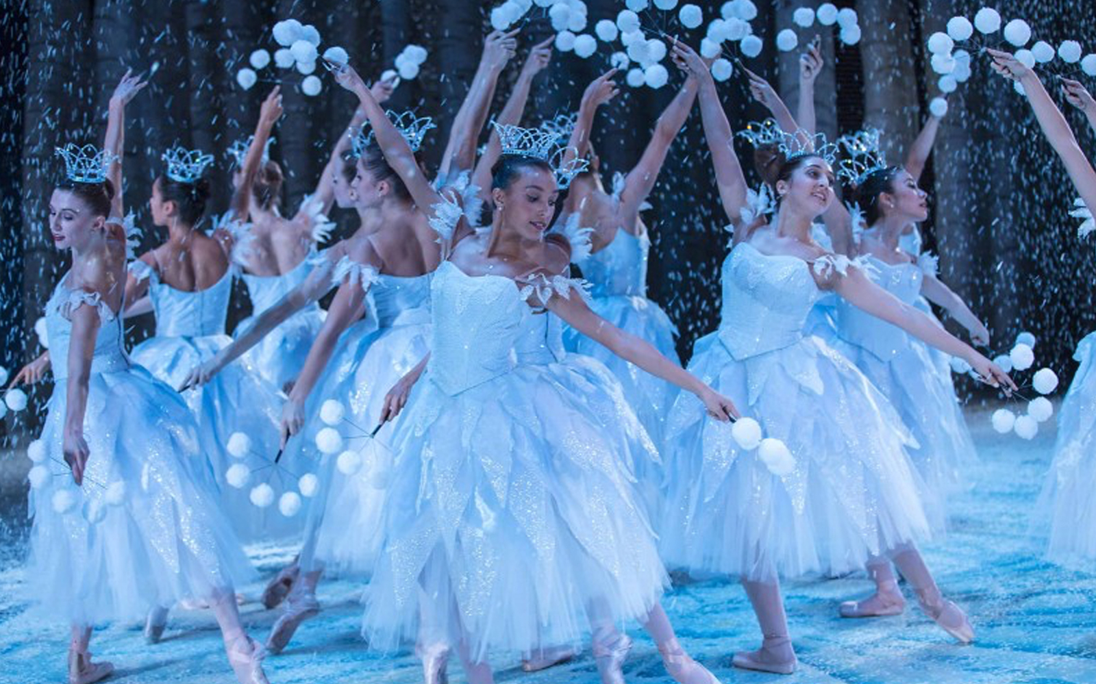 Ballet dancers in white costumes performing in George Balanchine's The Nutcracker.