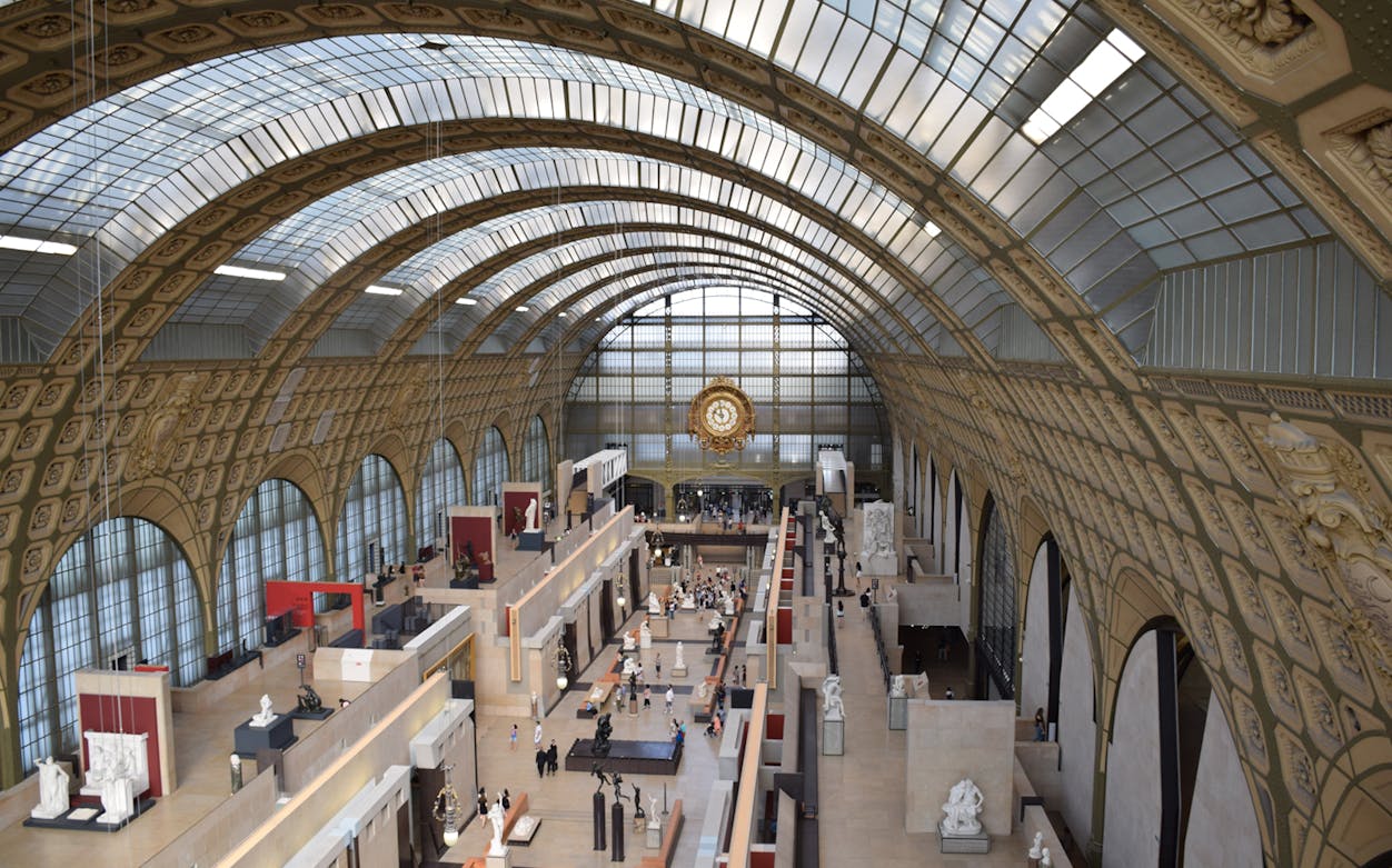 Orsay Museum interior with sculptures and iconic clock, Paris City Tour.