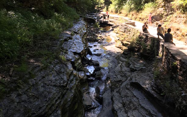 Watkins Glen gorge trail with rocky path and visitors exploring the scenic area.