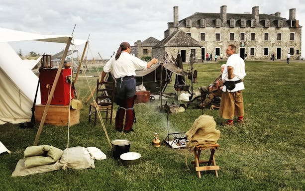 Historical reenactment at Fort Niagara with actors in period clothing, USA Secret Caverns/Watkins Glen + Niagara Falls 2-Day Tour.