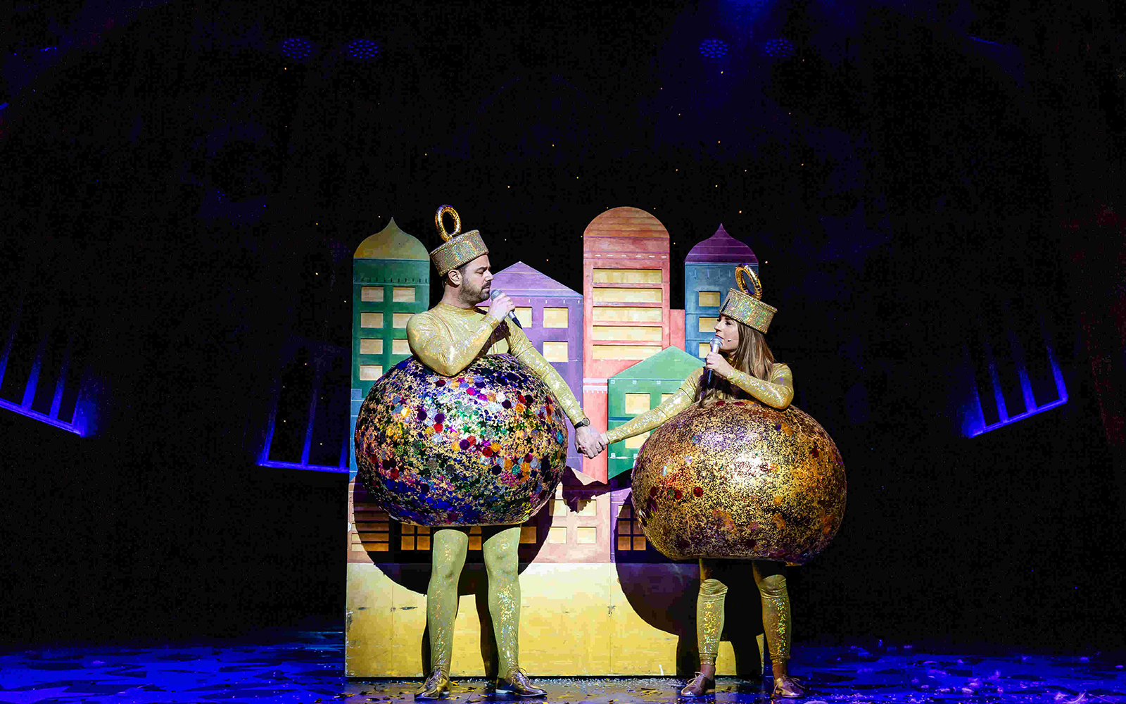 Performers in colorful costumes on stage during Nativity! The Musical.