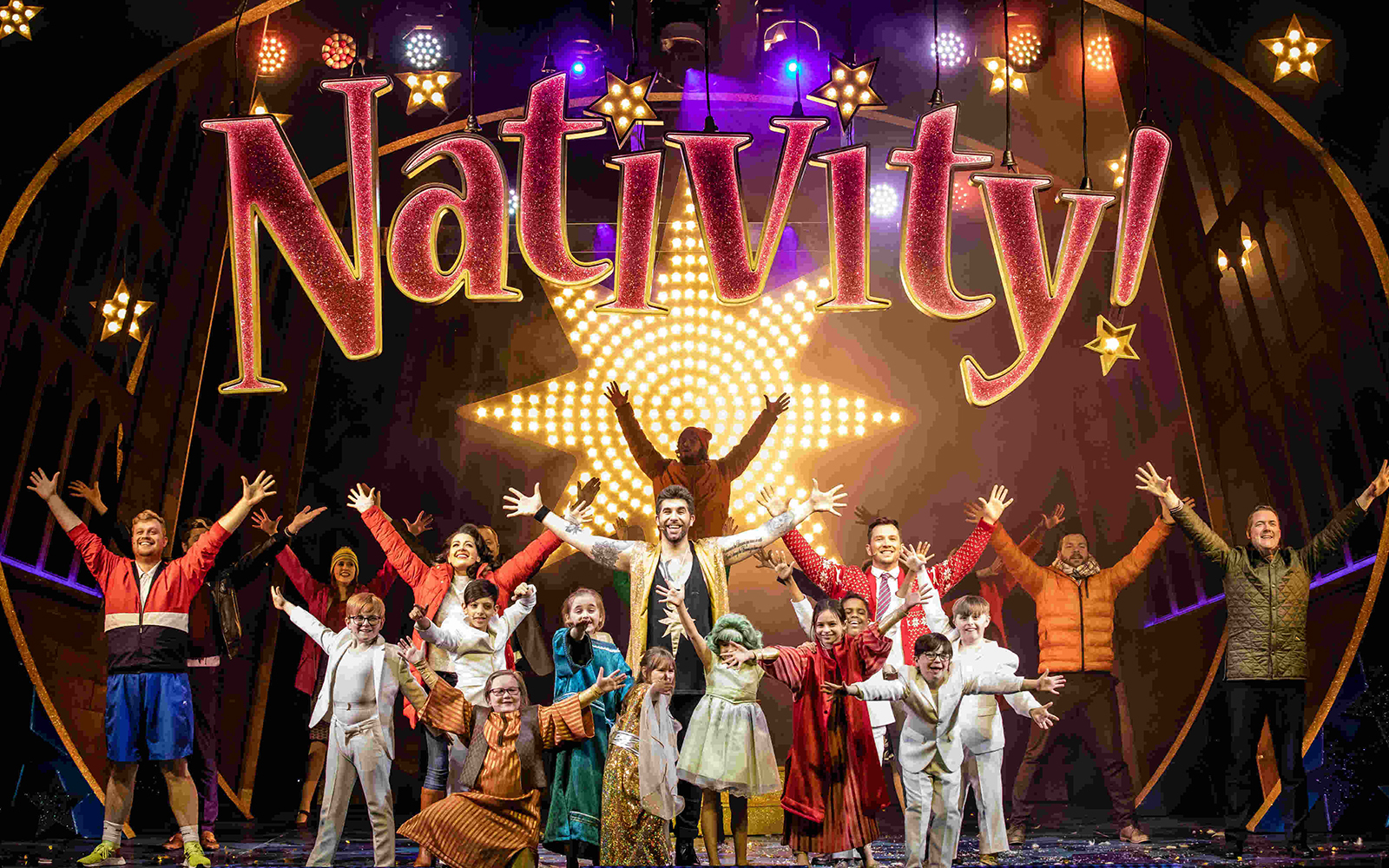 Performers on stage during "Nativity! The Musical" with a starry backdrop.