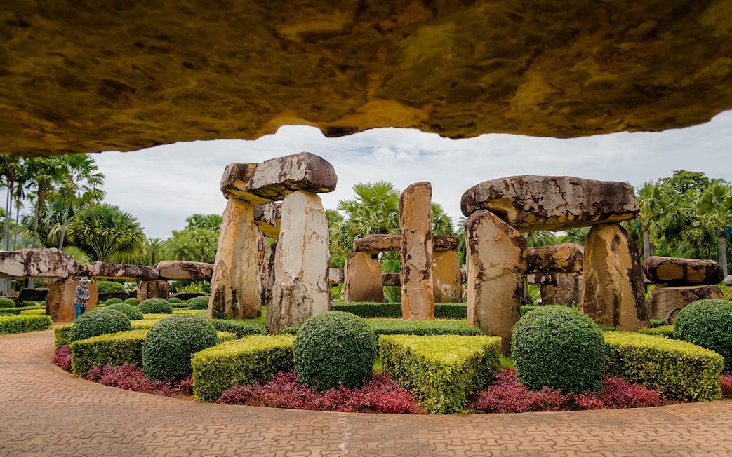 Stonehenge replica surrounded by manicured gardens at Nong Nooch Tropical Garden, Thailand.