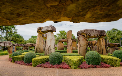 Stonehenge replica surrounded by manicured gardens at Nong Nooch Tropical Garden, Thailand.