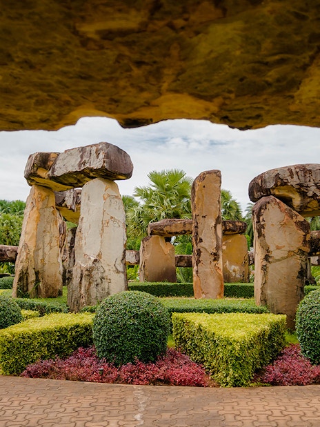 Stonehenge replica surrounded by manicured gardens at Nong Nooch Tropical Garden, Thailand.