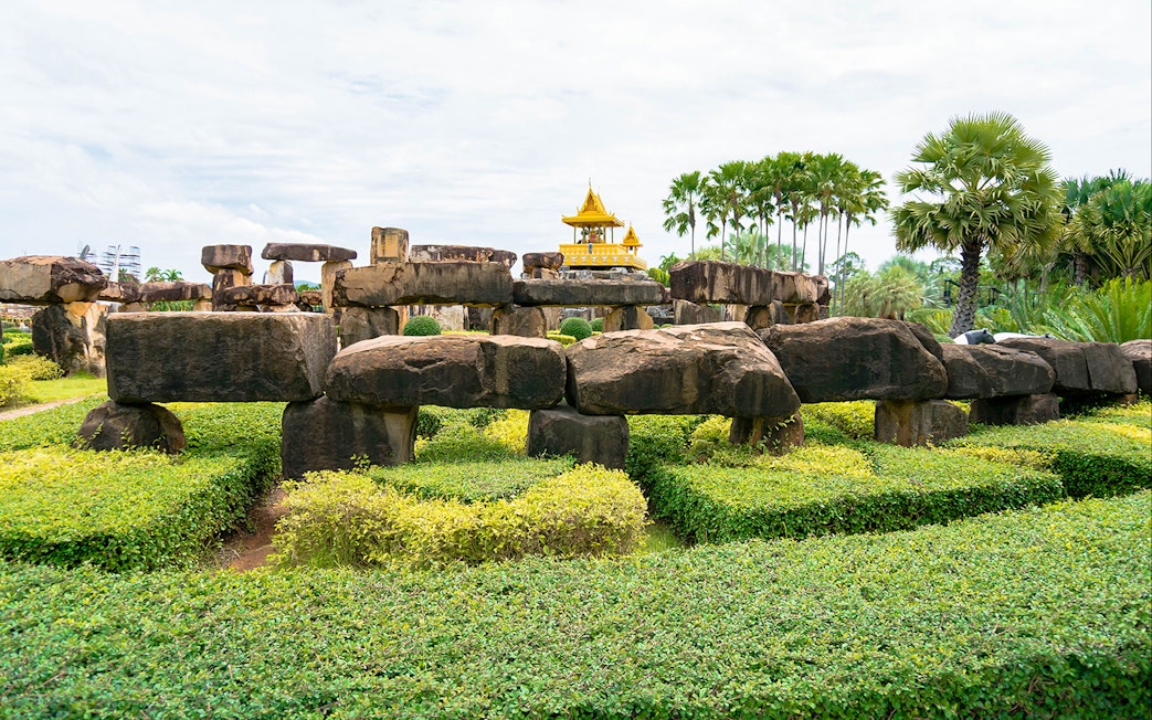 Stone structures and greenery at Nong Nooch Tropical Garden, Pattaya, Thailand.