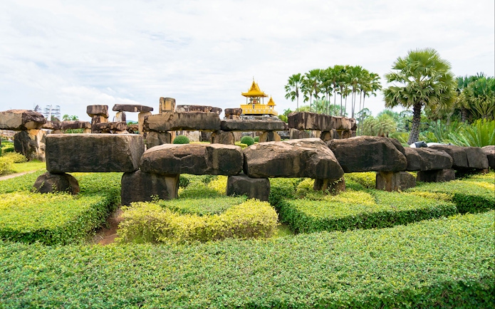 Stone structures and greenery at Nong Nooch Tropical Garden, Pattaya, Thailand.
