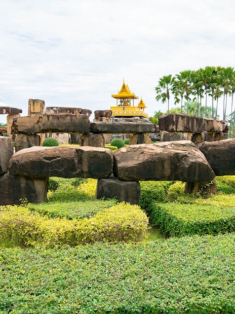 Stone structures and greenery at Nong Nooch Tropical Garden, Pattaya, Thailand.
