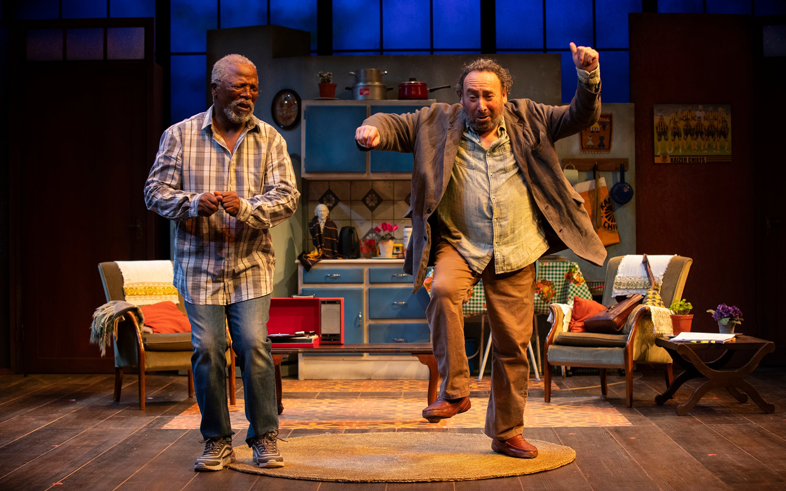 Two actors performing on stage in a scene from "Kunene and the King" play.