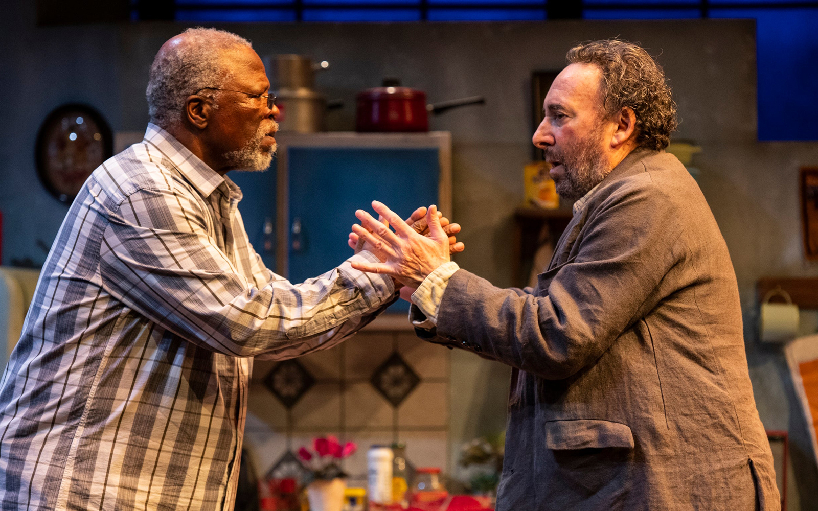 Two actors in a dramatic scene from "Kunene and the King" on stage.