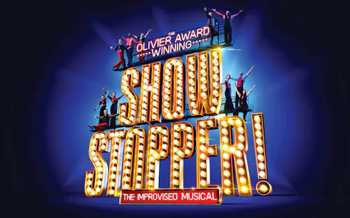 Showstopper! The Improvised Musical sign with performers on stage.