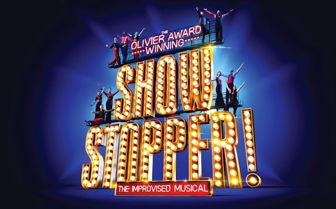 Showstopper! The Improvised Musical sign with performers on stage.