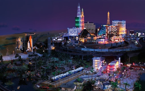 Miniatur Wunderland model with illuminated cityscape and train, showcasing iconic landmarks.