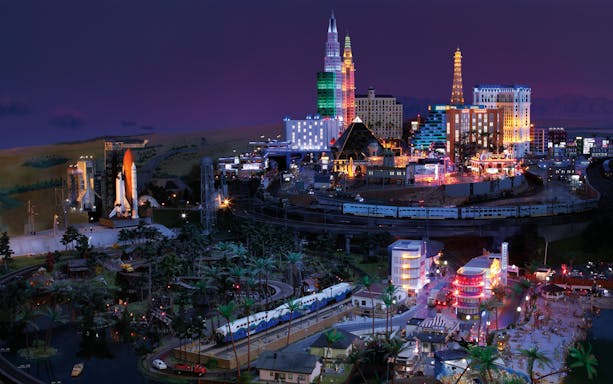 Miniatur Wunderland model with illuminated cityscape and train, showcasing iconic landmarks.