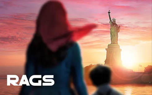 Two people viewing the Statue of Liberty at sunset, New York City.