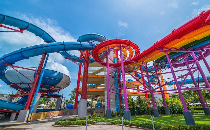 Colorful water slides at Splash Jungle Waterpark, featuring vibrant tubes and lush surroundings.