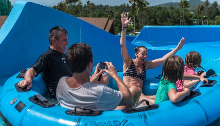 Tourists enjoying water rides at Splash Jungle Water Park