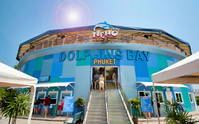 Phuket Dolphins Bay entrance with visitors buying tickets.