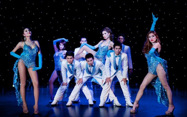 Performers in blue costumes on stage at Aphrodite Cabaret Show.